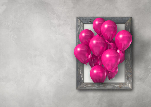 Pink air balloons group in a picture frame on concrete wall banner
