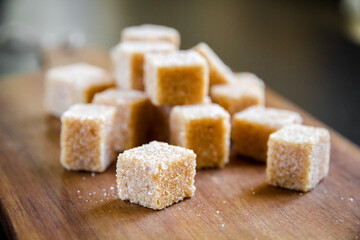 Brown cane sugar cubes on a cutting board