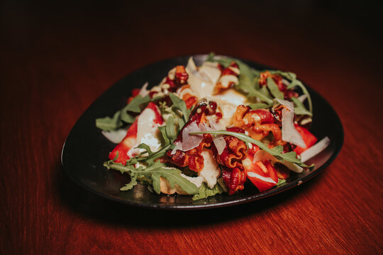 Closeup shot of a plate of delicious salad on a wooden table