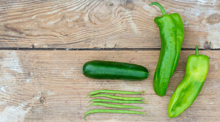 fresh vegetables on wooden table, cucumber and green peppers, asparagus bean pods. Pavilion food, vitamins