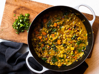 Rustic mung bean dahl curry in natural light. - obrazy, fototapety, plakaty