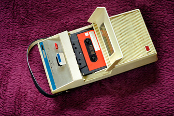 vintage cassette tape recorder and cassette tape from the seventies, vintage audio gear in full operation, flat lay