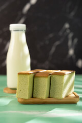matcha flavor cakes and bottle milk as a healthy breakfast vertical composition