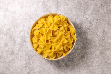 italian pasta, farfalle. Concrete background