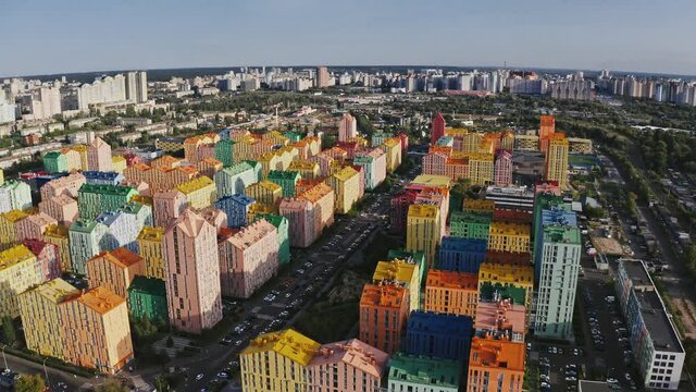 Drone footage of colorful district with residential buildings in city, tracking shot