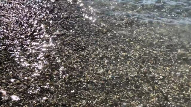 Sea waves wash the rocks on the beach