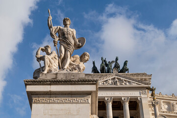 The sculptural group of the Force at the Altare della Patria or Vittoriano in Rome. The three characters are: a Roman centurion, a medieval warrior and a worker. Above the Quadriga of Liberty. Italy.