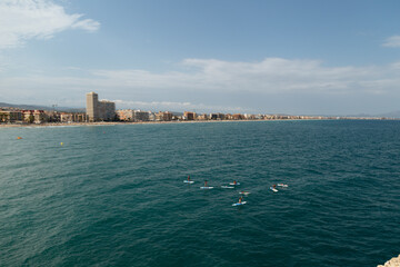 Fototapeta premium Stand up paddle boarding in Pacific surf.Stand up paddle boarding.Aerial bird's eye view photo taken by drone of stand up paddle surfing