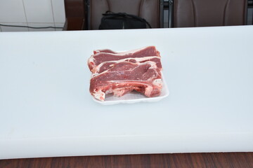 fresh chopped slices of lamb meat decorated in plate on white background,