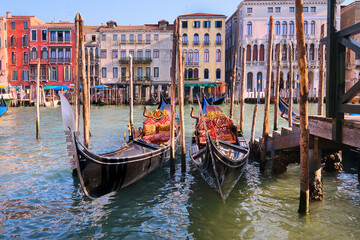 Gondolas moored by the pier on Grand Canal in Venice, Italy. © tilialucida