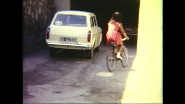  1968 Ankara Turkey: Cute girl on a bicycle. 8mm home movie.