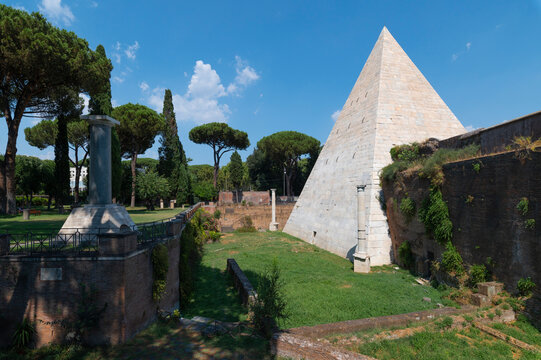 The Piramide Cestia or Pyramid of Cestius seen from the park of the non-Catholic cemetery is the only Egyptian-style pyramid in Rome. In the background the Aurelian walls at Porta San Paolo. Italy.
