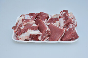 fresh chopped ribs of lamb meat isolated in plate on white background