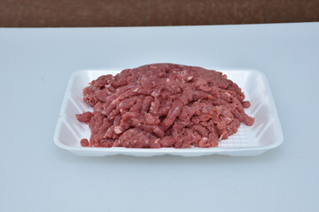 fresh organic mutton mince meat decorated in plate on white background