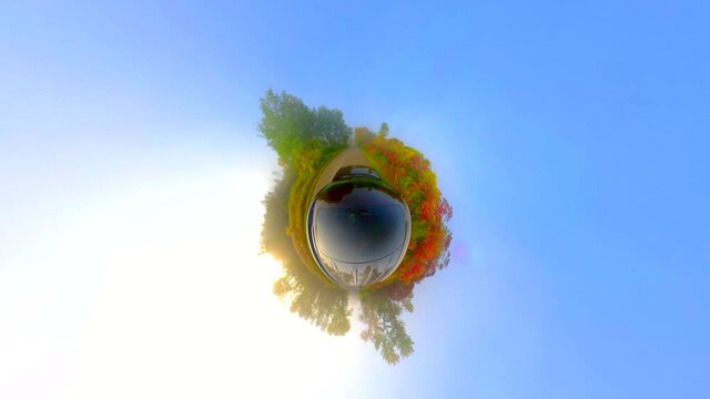 Fantastic tiny planet view of a Fall drive on country road, Autumn colors. 
