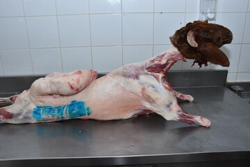 whole goat meat with goat head decorated on table