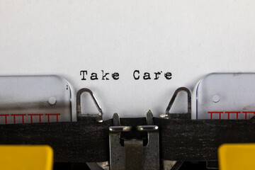 written on old typewriter with text Take Care