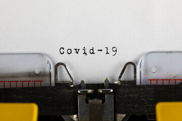 written on old typewriter with text Covid - 19. Covid-19, Coronavirus concept