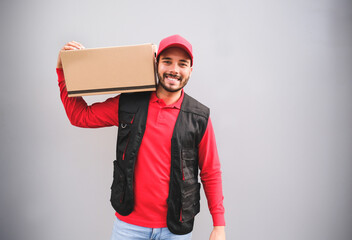 Portrait of cheerful delivery man smiling with package