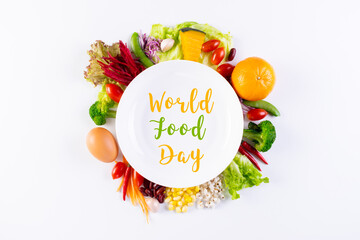 World food day, vegetarian day, Vegan day concept. Top view of fresh vegetables, fruit, with text in plate on white paper background.