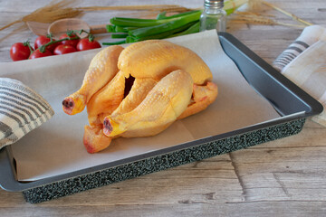 fresh and raw chicken on a baking tray