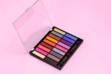 Obraz na płótnie Canvas Multi-colored eye shadow palette. Bright colors and shades in cosmetics. Minimalism cosmetic concept.