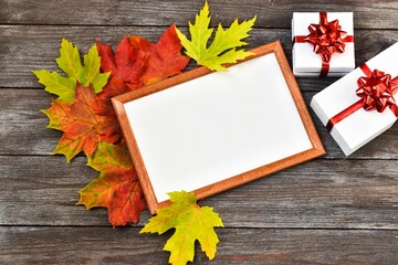Naklejka na ściany i meble Teachers day. Autumn composition. Workspace with blank notebook, gifts boxes with red ribbon and red maple leaves. Copy space.Top view, flat lay. Autumn concept. Greeting card. 