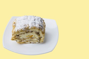 Close up view of cake in white plate on yellow background isolated. Food and health background.