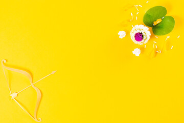 Happy Dussehra festival. The bow and gold arrow on yellow paper background with copy space for text.
