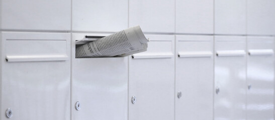 newspaper in the white mailbox. - 381145567