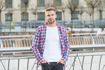 Looking good. student walk in city. handsome young man wear checkered shirt. casual dressed male...