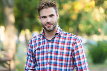 young unshaven man outdoor. male beauty and fashion. guy with bristle wear checkered shirt. concept...