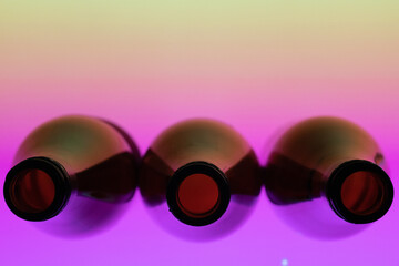 Three wine bottles views from top in a purple background