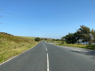 Fototapeta premium Looking along, the A58, toward the start of, Baitings Reservoir, on a hot summers day near, Ripponden, Halifax, UK