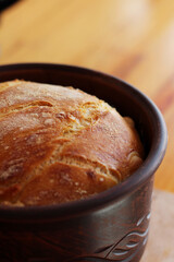 Fresh homemade bread in a clay pot. Homemade baking.