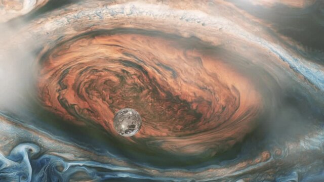 Ganymede, One of the four Galilean Moons orbiting Jupiter, passing over the Great Red Spot. Elements of this video furnished by NASA.