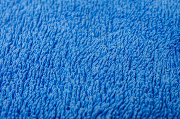 Close-up of soft turquoise towel texture background viewed from above.