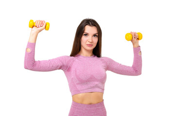 Young athletic woman in a lilac suit performs exercises on the shoulders with dumbbells
