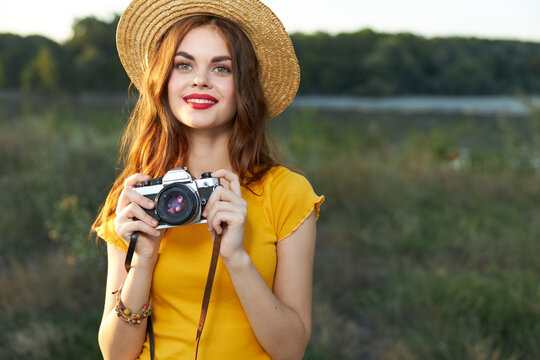 Pretty woman photographer in nature smile red lips attractive look