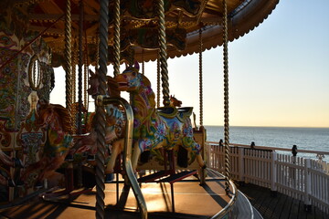 Merry go round on the Brighton pier during golden sunset