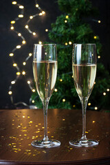 Two glasses full of sparkling champagne wine on table