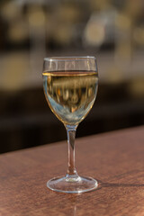 Glass of white wine on defocused background,outdoor.