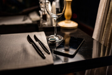 Fototapeta na wymiar still life with knives and forks on a napkin on a dark background