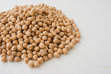 Closeup of the chickpea on white wooden background.