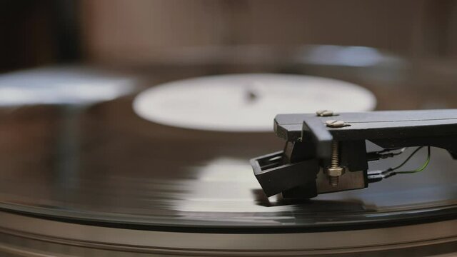 Cinemagraph vinyl record is spinning. Old retro turntable.turntable stylus on a record