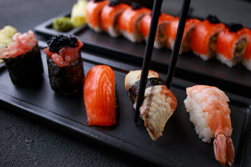 Eating sushi. Chopsticks taking eel nigiri sushi
