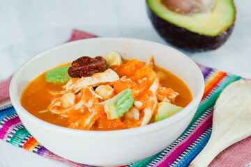 Caldo Tlalpeño with avocado and spoon