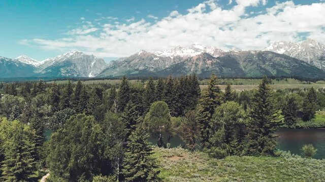 Grand Teton National Park, panoramic aerial view from drone in summer season. Slow motion