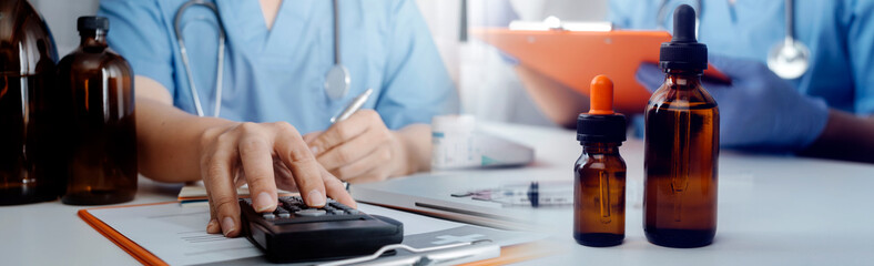 Medical technology concept The doctor works with mobile phones, headphones and tablets. Digital laptop Pressing the calculator in the modern office at the hospital in the morning