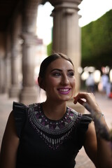 Fototapeta premium latin girl, student using cellphone while sitting in a coffee shop in mexico, queretaro beauty